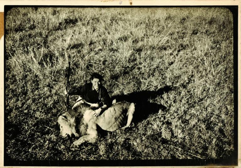 Virginia Kraft poses with a male African Lion.