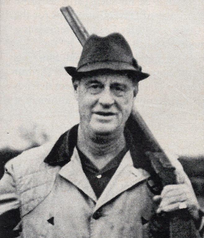 Charles Payson poses for a portrait with his rifle in hand. 