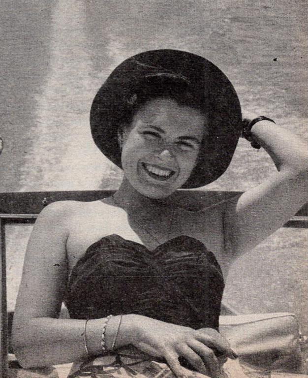 Virginia Kraft smiles in a swimsuit in hat, aboard a boat. 