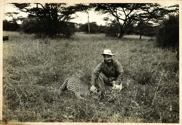 Robert Grimm kneels by a jaguar in an undated photo. 